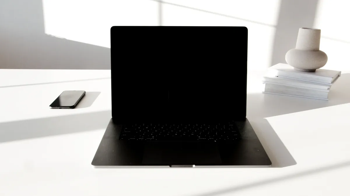 A laptop on a bright, uncluttered desk