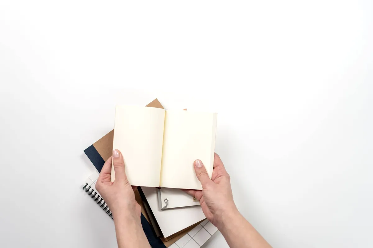 An open notebook on a bright, plain surface